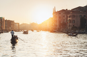 Gondolas and boats in the Grand Canal during sunset