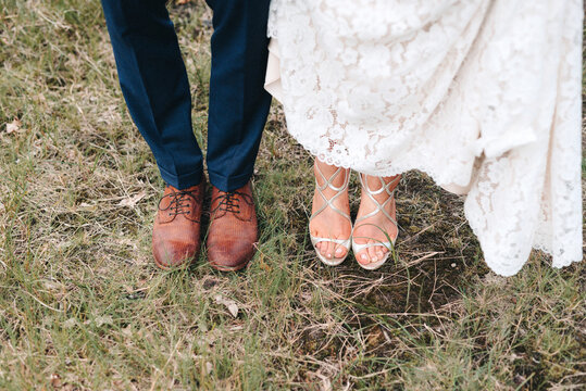 bride and groom shoes on grass