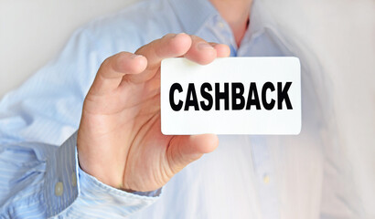 Business man holding a business card. The content of the lettering has implications for business concept and marketing.