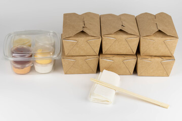 Food delivery service concept. Asian food in eco paper take away boxes with sauces. Meal diet plan for daily ready menu.