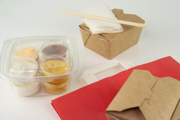 Food delivery service concept. Asian food in eco paper take away boxes with sauces. Meal diet plan for daily ready menu.