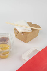 Food delivery service concept. Asian food in eco paper take away boxes with sauces. Meal diet plan for daily ready menu.