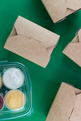 Food delivery service concept. Food in eco paper take away boxes with sauces. Meal diet plan for daily ready menu.