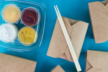 Food delivery service concept. Asian food in eco paper take away boxes with sauces. Meal diet plan for daily ready menu.