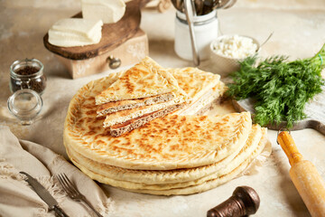 National traditional Caucasian cuisine: Ossetian pies, khachapuri, chudu. Assorted pies with different fillings: meat, cheese, herbs