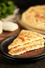 National traditional Caucasian cuisine: Ossetian pies, khachapuri, chudu. Assorted pies with different fillings: meat, cheese, herbs