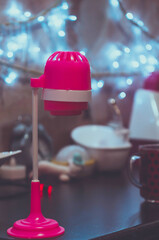 Pink children's lamp on the rack. Toy, selective focus.