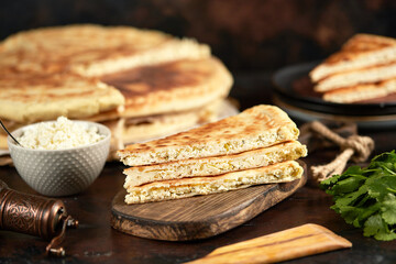 National traditional Caucasian cuisine: Ossetian pies, khachapuri, chudu. Assorted pies with different fillings: meat, cheese, herbs