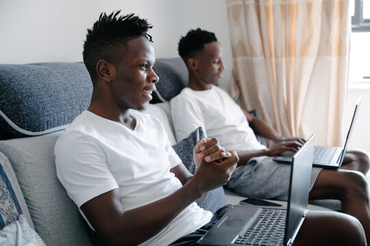 Black men use laptop at home