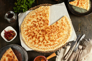 National traditional Caucasian cuisine: Ossetian pies, khachapuri, chudu. Assorted pies with different fillings: meat, cheese, herbs