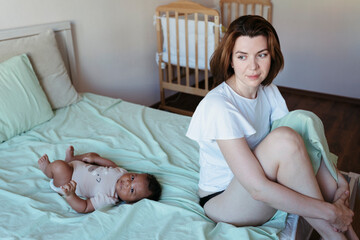 Young mother with her newborn baby.