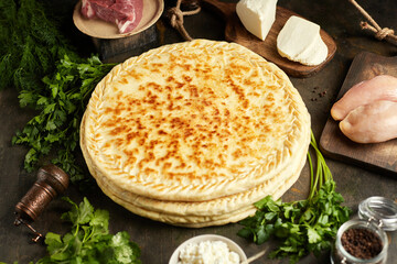 National traditional Caucasian cuisine: Ossetian pies, khachapuri, chudu. Assorted pies with different fillings: meat, cheese, herbs