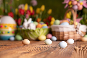Fototapeta na wymiar Easter theme. Easter eggs. Colorful tulips. Easter baskets. Rustic wooden table. 