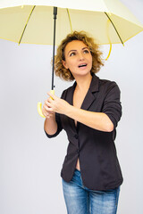 Beautiful free girl with an umbrella, woman in a dark jacket.