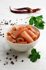 Jerky meat in a white bowl on a light background