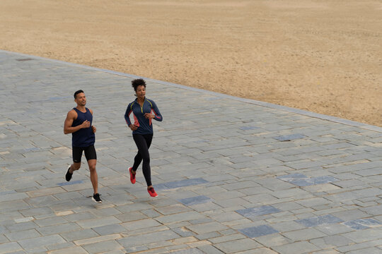 Couple Running Beside the beach