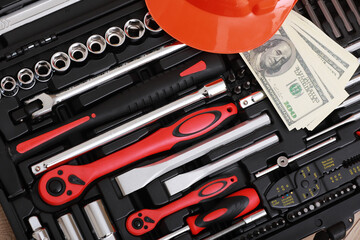 Fototapeta premium Toolbox, tools kit detail, dollar bills and orange protective helmet close up. instruments. set of tools. car tool kit. tool set background. instruments for repair. money for repairs