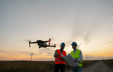 Construction workers inspecting wind turbines