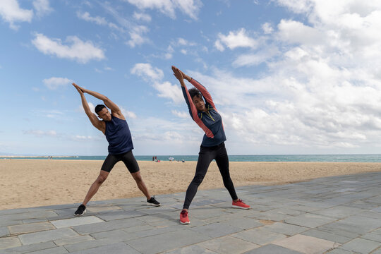 Couple Stretching by the Beach
