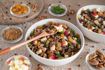 Bowl of vegetarian mixed salad, with lentils, apples, nuts and spices