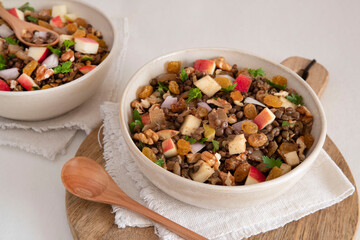 Bowl of vegetarian mixed salad, with lentils, apples, nuts and spices