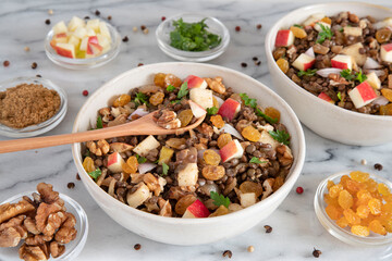 Bowl of vegetarian mixed salad, with lentils, apples, nuts and spices