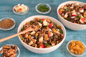 Bowl of vegetarian mixed salad, with lentils, apples, nuts and spices