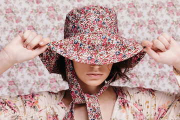 Young woman adjusting summer hat