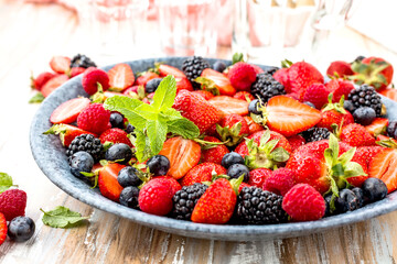 Berries colorful assorted mix of strawberry, blueberry, raspberry, blackberry on dark background