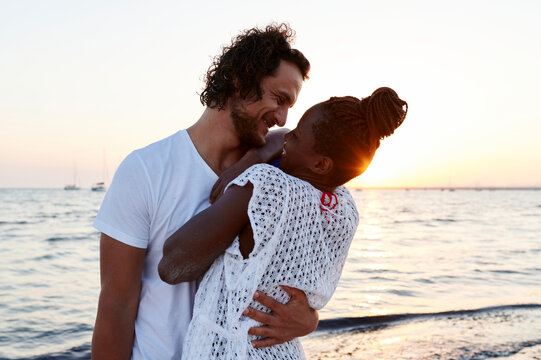 Man hugging his girlfriend at the beach
