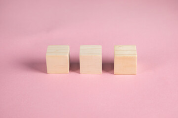 empty wooden cubes on pink background