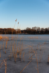 Frozen lake during sunset. Beautiful winter landscape. Selective focus. 
