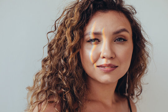 Woman with rainbow on face