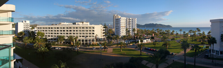 Panoramic view of vacant hotels and a park in the corona lockdown off-season at Cala Millor Beach, Mallorca in Spain