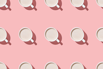 A seamless pattern of coffee and cocoa with cream on a pink table flat lay above