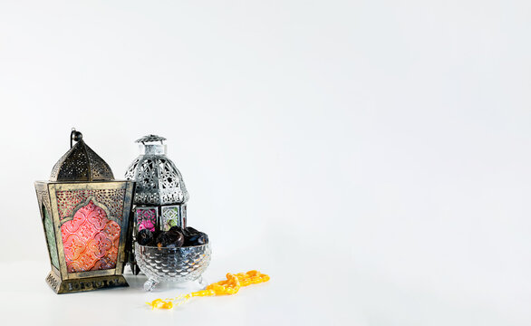 Background image with white background with arabic lantern, dates and beads.
