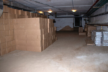 Cardboard boxes with goods in the basement.