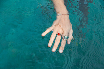 Hand with rings on the water