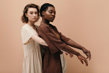 Diverse trendy women hugging gently