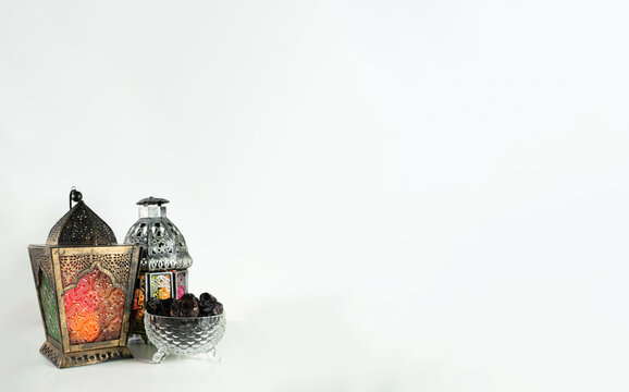 Background image with white background with arabic lantern, dates and beads.
