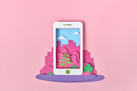 Papercraft smartphone on a background of craft city.