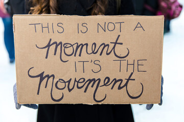 Woman holding protest sign