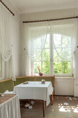 Table in abandoned hotel, broken tableware in many shards