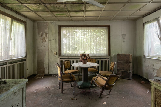 Table in abandoned run-down hotel, haunted scene