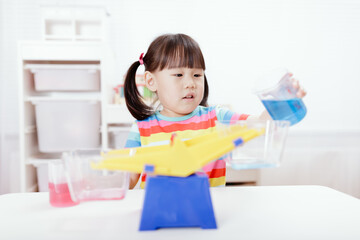 young girl play balance toy for homeschooling