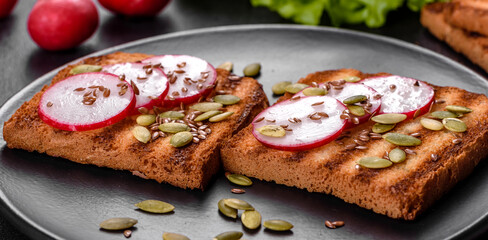 Delicious crisp sandwich with toast, radish, pumpkin seeds and flax seeds