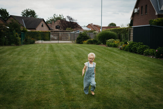little boy running around in the garden