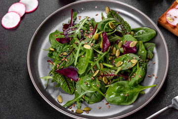 Fresh juicy salad with leaves of mangold, arugula, spinach and beets