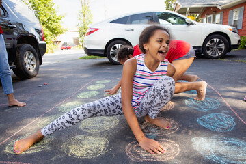 Kids outside playing twister in the driveway