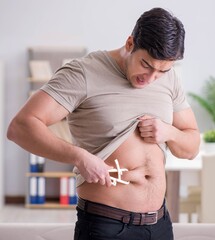 Man measuring body fat with calipers